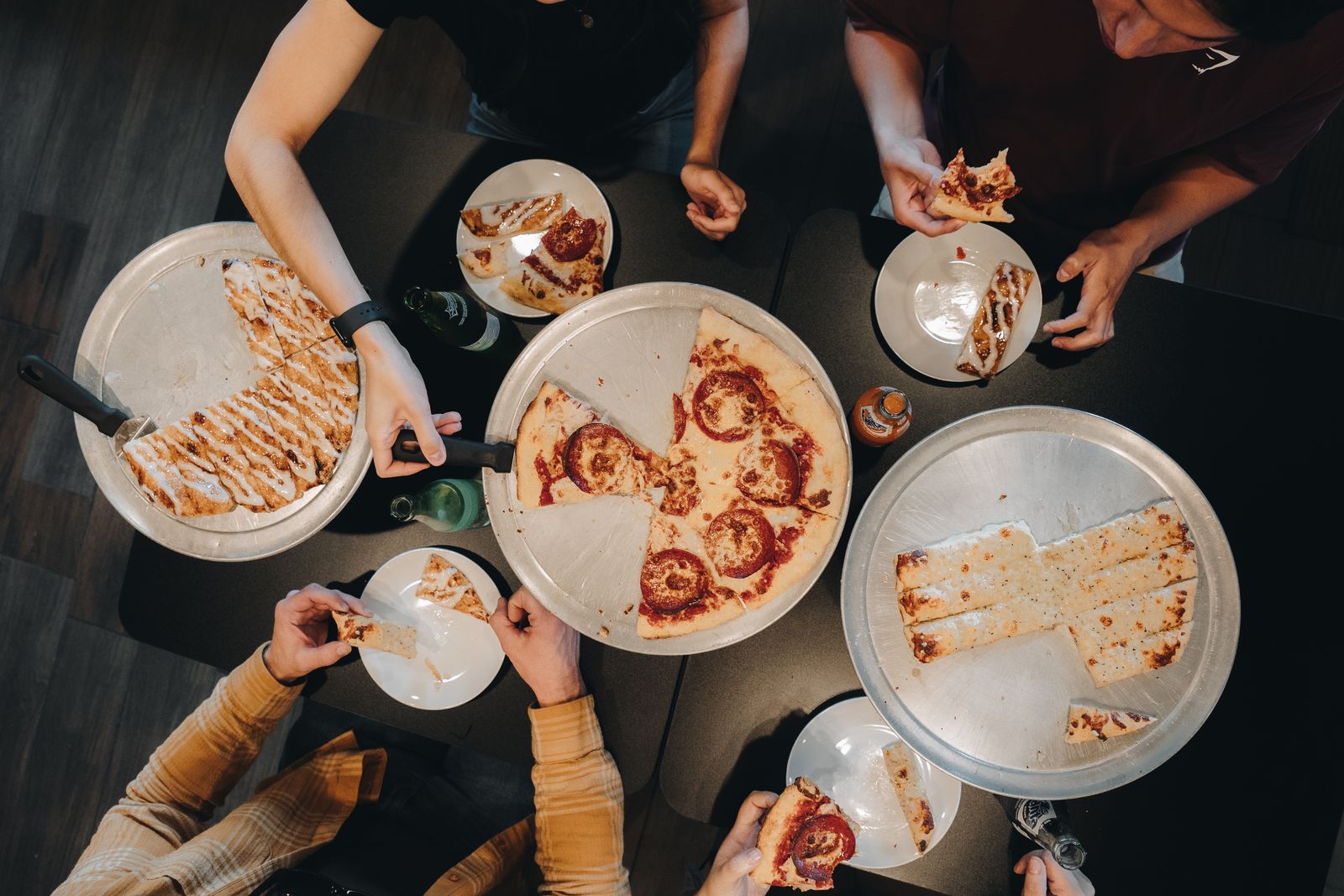 Friends sharing pizzas around a table at Blue Buffalo Pizzeria in Island Park, Idaho